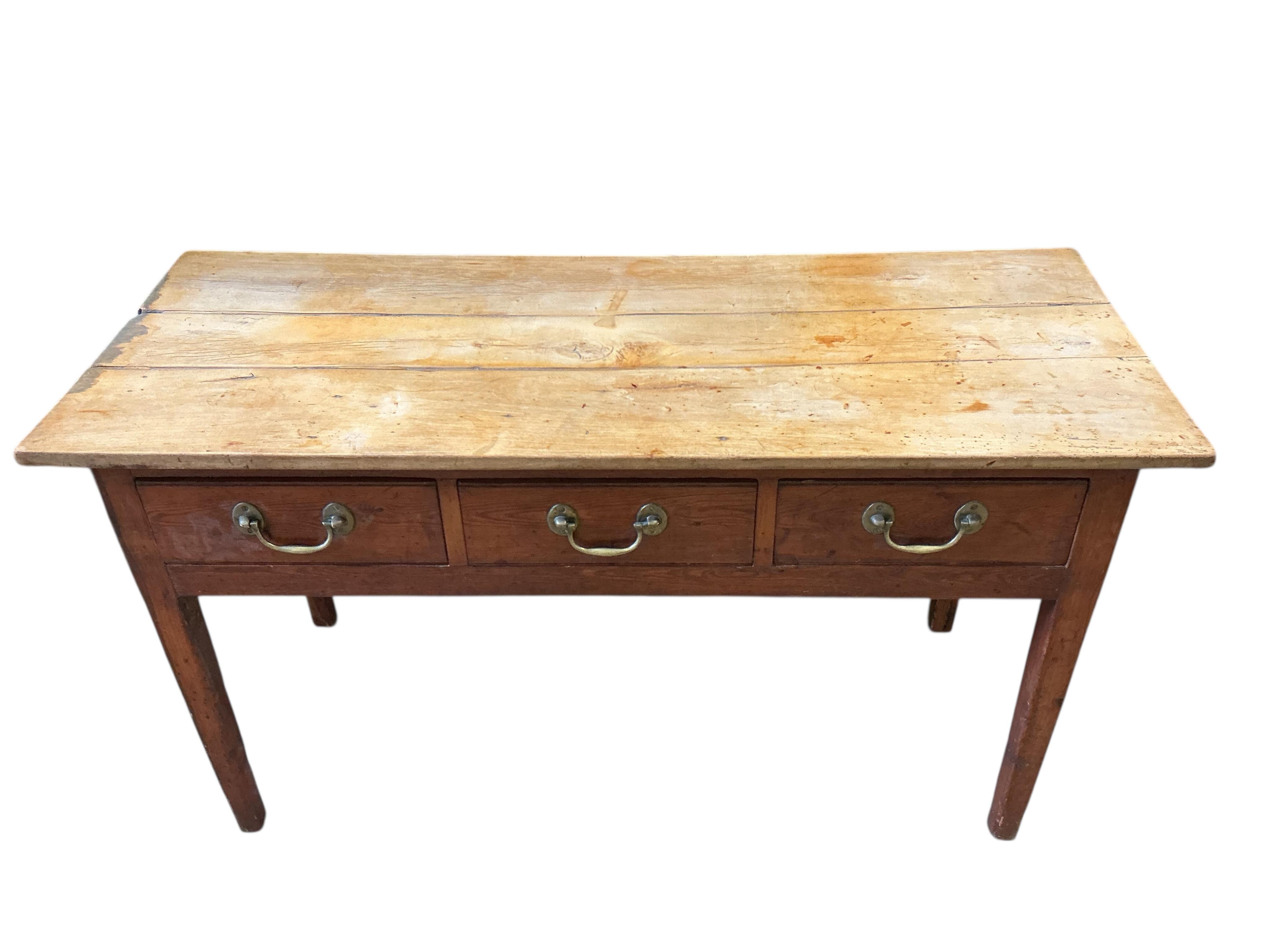 An early 19th century pine and fruitwood three drawer serving table, width 137cm, depth 54cm, height 75cm
